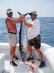 2 guys Holding Tuna